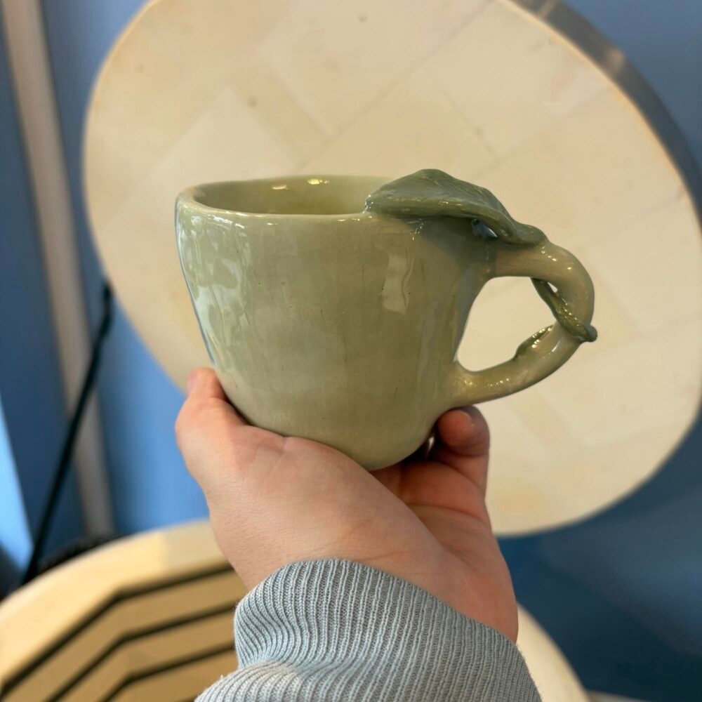 Ολοκληρωμένη γυαλωμένη κούπα με λαβή φύλλο, φτιαγμένη από μαθητή στα μαθήματα κεραμικής στο εργαστήριό μας Theta for Ceramics στου Ζωγράφου.